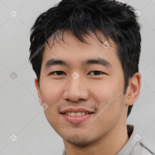 Joyful asian young-adult male with short  black hair and brown eyes