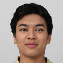 Joyful asian young-adult male with short  black hair and brown eyes