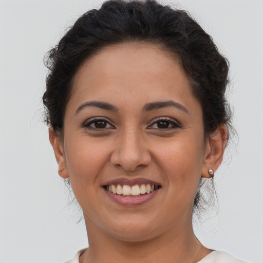 Joyful latino young-adult female with short  brown hair and brown eyes