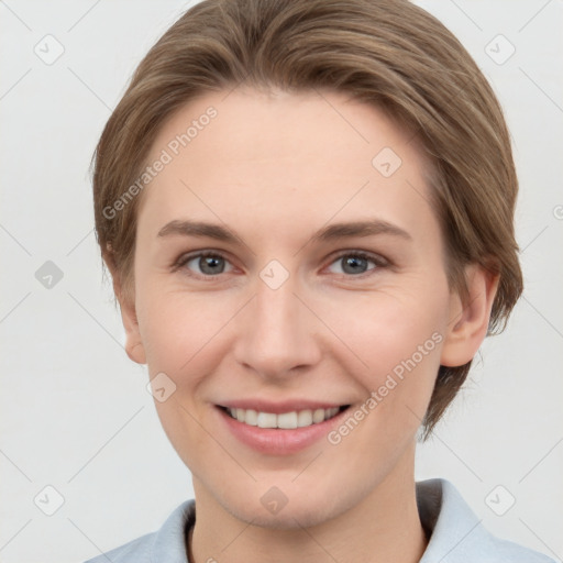 Joyful white young-adult female with short  brown hair and grey eyes