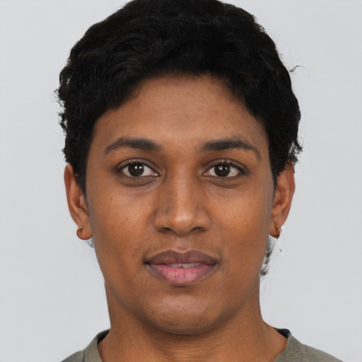 Joyful black young-adult female with short  black hair and brown eyes