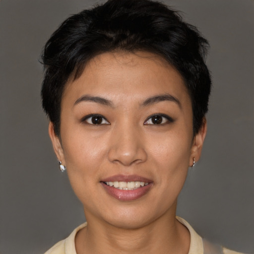 Joyful latino young-adult female with short  brown hair and brown eyes