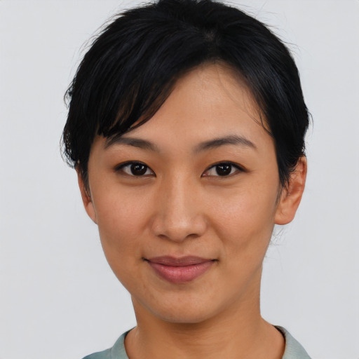 Joyful asian young-adult female with short  black hair and brown eyes