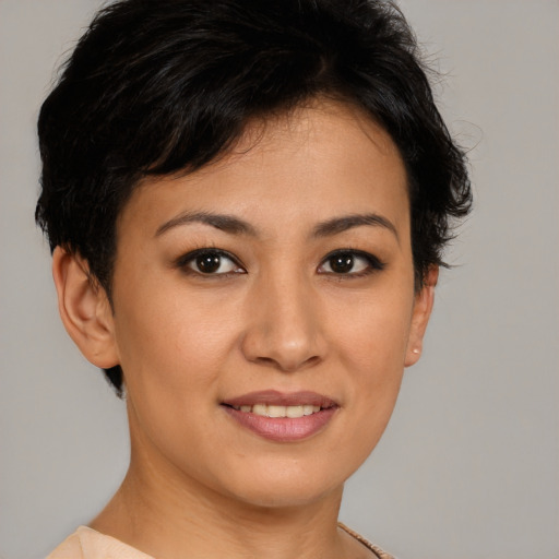 Joyful asian young-adult female with short  brown hair and brown eyes