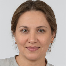 Joyful white adult female with medium  brown hair and brown eyes