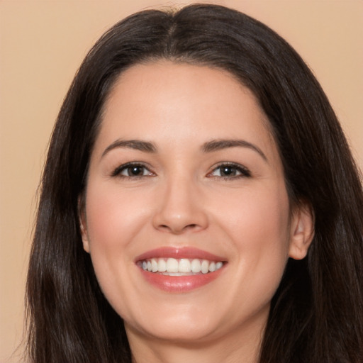 Joyful white young-adult female with long  brown hair and brown eyes