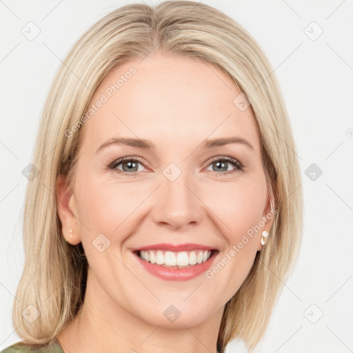 Joyful white adult female with long  brown hair and blue eyes