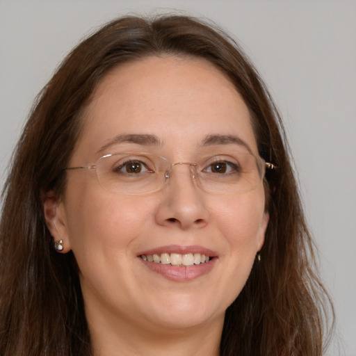 Joyful white adult female with long  brown hair and brown eyes