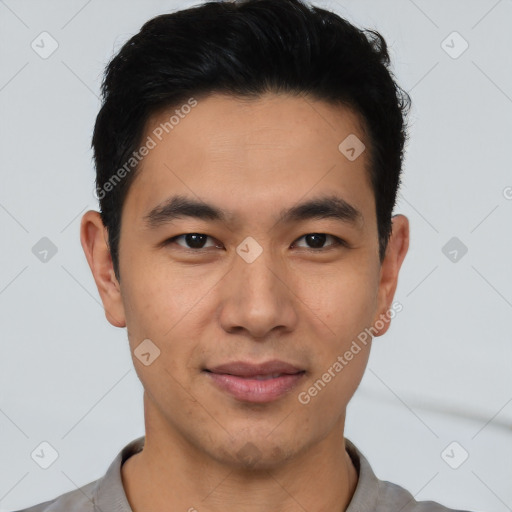 Joyful asian young-adult male with short  black hair and brown eyes