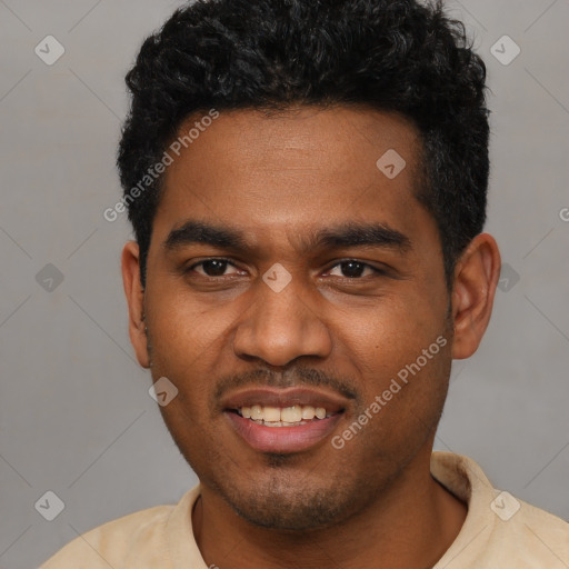 Joyful black young-adult male with short  black hair and brown eyes