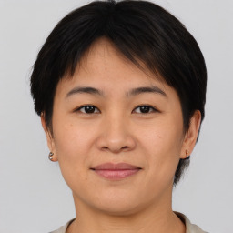 Joyful asian young-adult female with short  brown hair and brown eyes