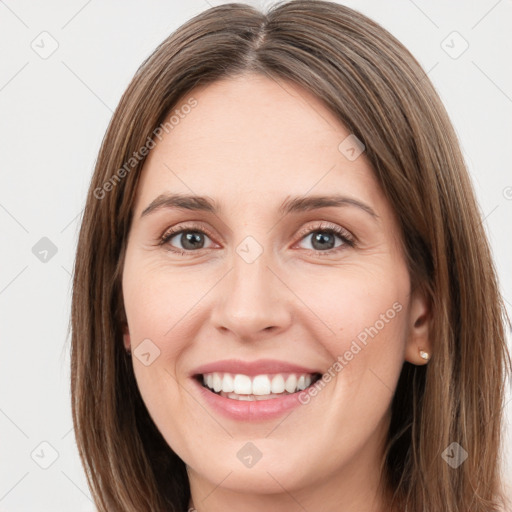 Joyful white young-adult female with long  brown hair and green eyes