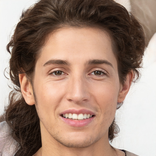 Joyful white young-adult male with medium  brown hair and brown eyes