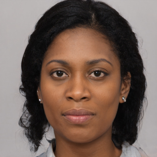 Joyful latino young-adult female with medium  black hair and brown eyes