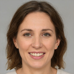 Joyful white adult female with medium  brown hair and brown eyes