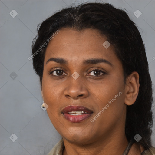 Joyful black adult female with long  brown hair and brown eyes