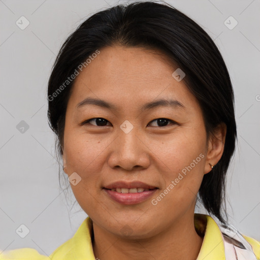 Joyful asian adult female with medium  brown hair and brown eyes