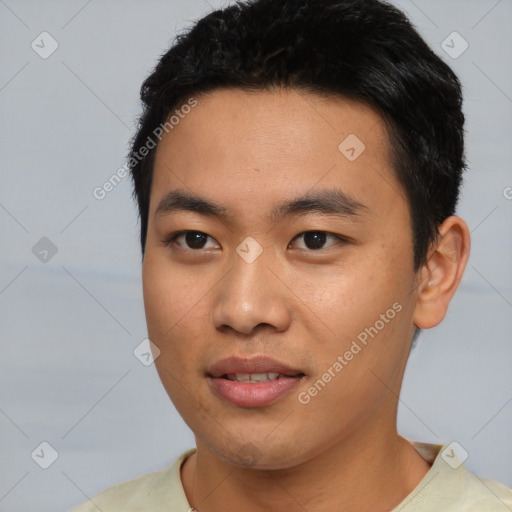 Joyful asian young-adult male with short  black hair and brown eyes