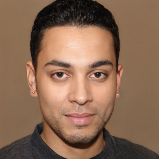 Joyful white young-adult male with short  black hair and brown eyes