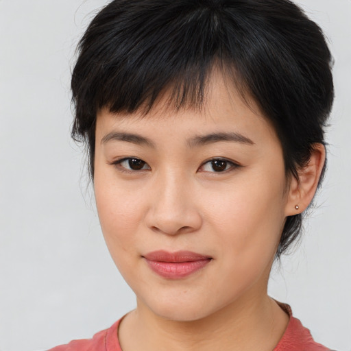 Joyful asian young-adult female with medium  brown hair and brown eyes