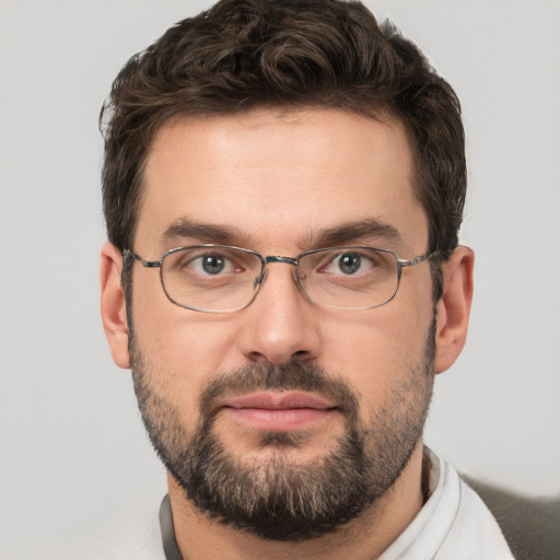 Joyful white adult male with short  brown hair and brown eyes