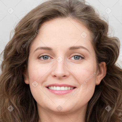 Joyful white young-adult female with long  brown hair and blue eyes