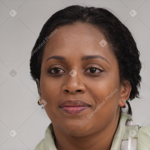 Joyful black adult female with medium  brown hair and brown eyes