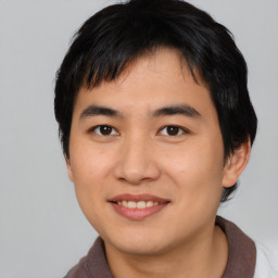 Joyful asian young-adult male with short  black hair and brown eyes