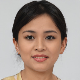 Joyful asian young-adult female with medium  brown hair and brown eyes