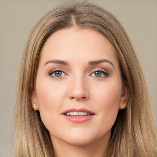 Joyful white young-adult female with long  brown hair and grey eyes