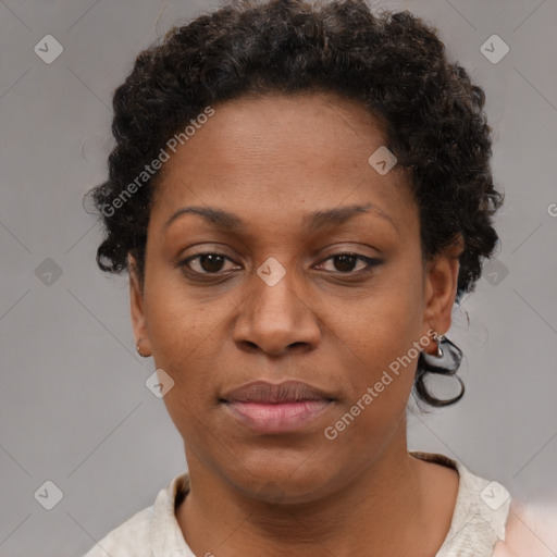 Joyful black adult female with short  brown hair and brown eyes