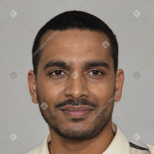 Joyful black young-adult male with short  black hair and brown eyes