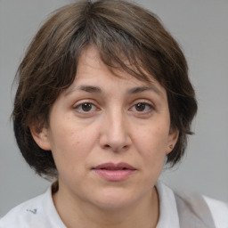 Joyful white adult female with medium  brown hair and brown eyes