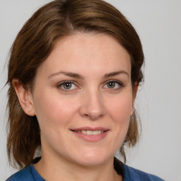 Joyful white young-adult female with medium  brown hair and blue eyes