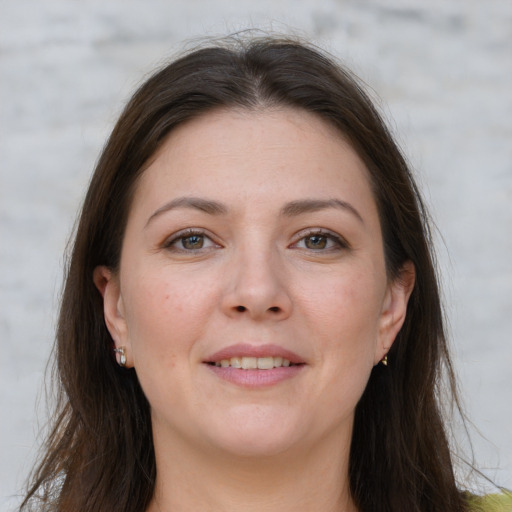 Joyful white young-adult female with long  brown hair and grey eyes