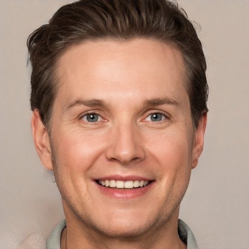 Joyful white adult male with short  brown hair and grey eyes