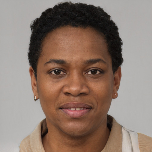 Joyful black adult female with short  black hair and brown eyes