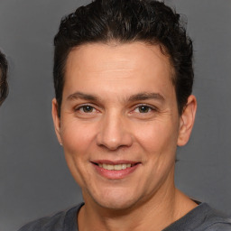 Joyful white adult male with short  brown hair and brown eyes