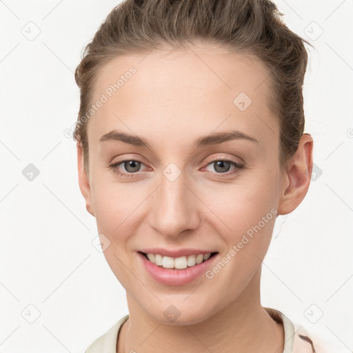 Joyful white young-adult female with short  brown hair and grey eyes