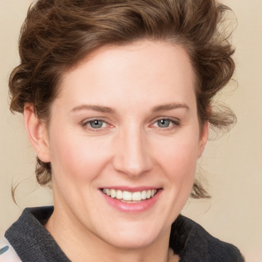 Joyful white young-adult female with medium  brown hair and green eyes