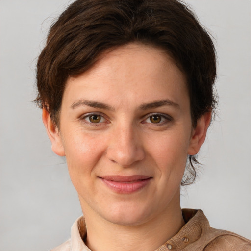 Joyful white young-adult female with short  brown hair and grey eyes