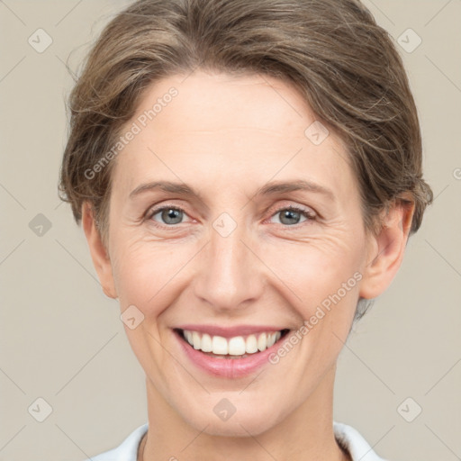 Joyful white adult female with short  brown hair and grey eyes