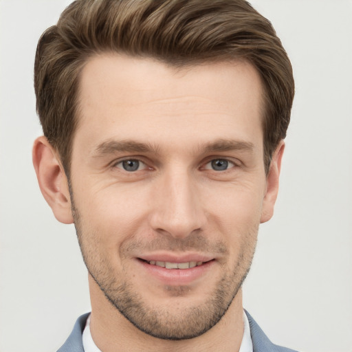 Joyful white young-adult male with short  brown hair and grey eyes