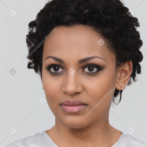 Joyful black young-adult female with short  black hair and brown eyes