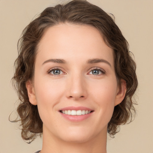 Joyful white young-adult female with medium  brown hair and green eyes