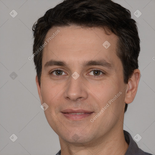 Joyful white adult male with short  brown hair and brown eyes