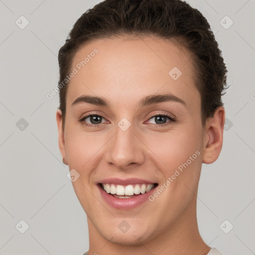 Joyful white young-adult female with short  brown hair and brown eyes