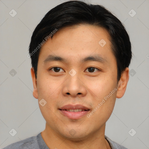 Joyful asian young-adult male with short  black hair and brown eyes