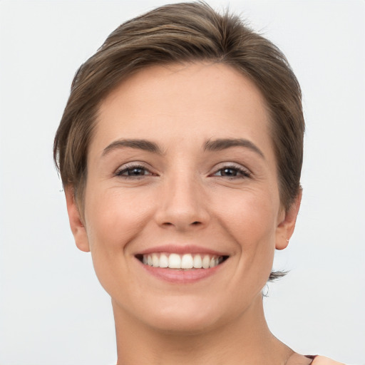 Joyful white young-adult female with short  brown hair and brown eyes