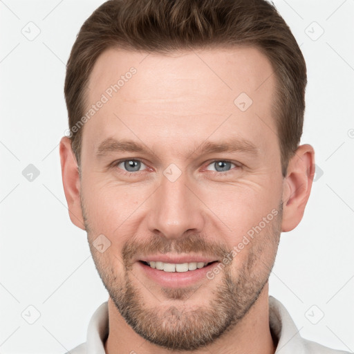 Joyful white young-adult male with short  brown hair and grey eyes